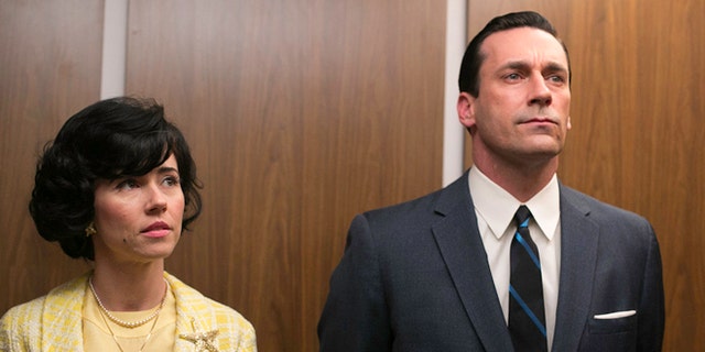 This TV publicity image released by AMC shows Linda Cardellini as Sylvia Rosen, left, and Jon Hamm as Don Draper in a scene from "Mad Men."