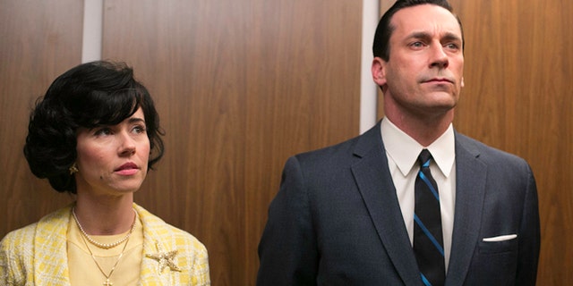 This TV publicity image released by AMC shows Linda Cardellini as Sylvia Rosen, left, and Jon Hamm as Don Draper in a scene from "Mad Men."