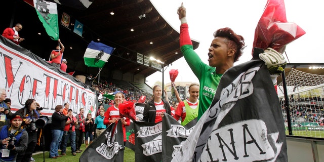 FILE - In this April 21, 2013, file photo, Portland Thorns goalie Karina LeBlanc, right, celebrates with teammates and fans after their 2-0 win over the Seattle Reign in a National Women's Soccer League match in Portland, Ore. The Thorns' season couldn't be going any better. They're sitting atop the league standings and drawing more than 10,000 fans to home games. AP Photo/Don Ryan, File)
