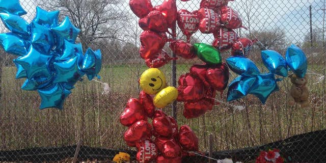 A makeshift memorial sits along a fence Monday, April 17, 2017, near where Robert Godwin Sr., was killed in Cleveland. Police said Steve Stephens killed Godwin on Sunday and posted the video on Facebook. (AP Photo/Mike Householder)