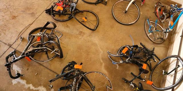 FILE- In this June 9, 2016 file photo, mangled bicycles are tagged as evidence at the Michigan State Police crime lab in Kalamazoo, Mich. The National Transportation Safety Board says better communication between police agencies might have prevented the deaths of five bicyclists last year in southwestern Michigan. A pickup truck plowed into cyclists on a rural road near Kalamazoo last June. The NTSB says 22 minutes passed between the first 911 call about an erratic driver and the crash. The board says Charles Pickett Jr. might have been stopped if dispatchers for three police agencies had shared more information. (Mark Bugnaski/Kalamazoo Gazette-MLive Media Group via AP)