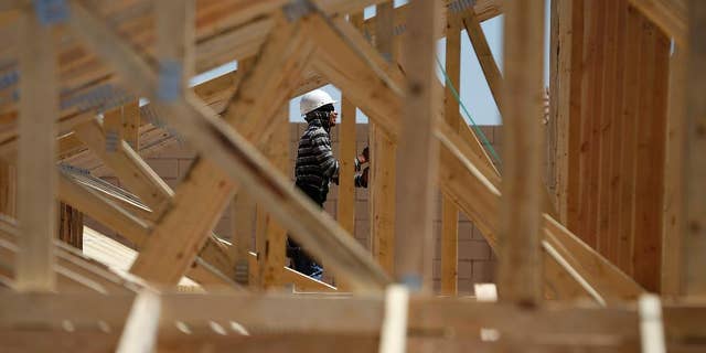 In this April 13, 2015, photo, a worker helps to frame a new home at a housing tract in Las Vegas. The Commerce Department reports on U.S. construction spending in March on Friday, May 1, 2015. (AP Photo/John Locher)