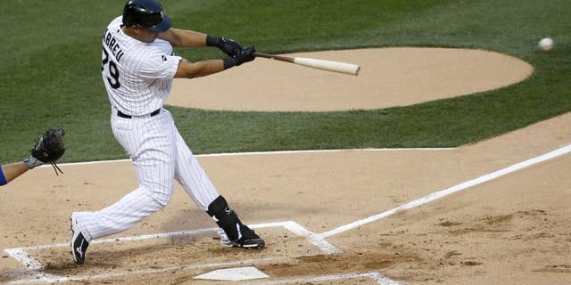 Chicago White Sox's Jose Abreu hits a single off Chicago Cubs starting pitcher Jake Arrieta during the first inning of an interleague baseball game Thursday, May 8, 2014, in Chicago. (AP Photo/Charles Rex Arbogast)