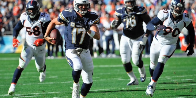 San Diego Chargers quarterback Philip Rivers scrambles away from the Denver Broncos defense in the first quarter of an NFL football game Sunday Nov. 10, 2013 in San Diego. (AP Photo/Denis Poroy)