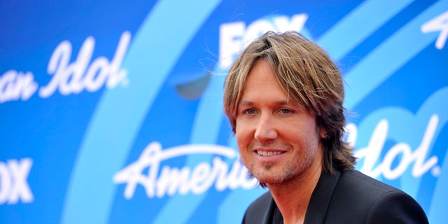 In this May 16, 2013 photo, Keith Urban arrives at the "American Idol" finale at the Nokia Theatre at L.A. Live in Los Angeles. The Australian country music star has set a release date of Sept. 10 for his new album, "Fuse." (Photo by Chris Pizzello/Invision/AP)