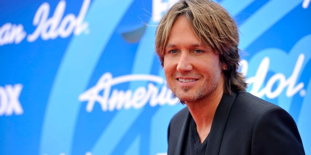In this May 16, 2013 photo, Keith Urban arrives at the "American Idol" finale at the Nokia Theatre at L.A. Live in Los Angeles. The Australian country music star has set a release date of Sept. 10 for his new album, "Fuse." (Photo by Chris Pizzello/Invision/AP)