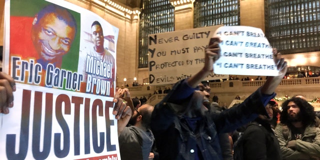 People protest in Grand Central Terminal on Wednesday, Dec. 3, 2014, in New York.