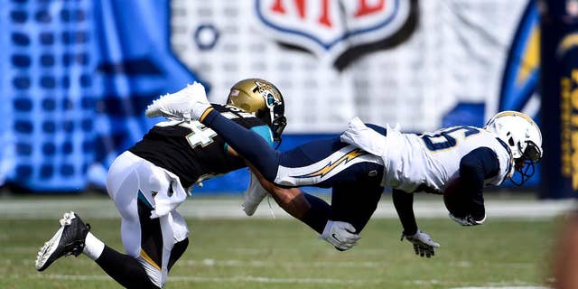 San Diego Chargers cornerback Brandon Flowers intercepts a pass in front of Jacksonville Jaguars wide receiver Cecil Shorts during the second half of an NFL football game Sunday, Sept. 28, 2014, in San Diego. (AP Photo/Denis Poroy)
