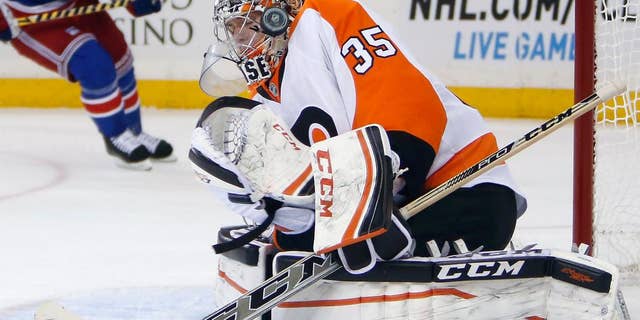 Philadelphia Flyers goalie Steve Mason (35) deflects a shot during the second period of an NHL preseason hockey game against the New York Rangers, Monday, Sept. 29, 2014, in New York. (AP Photo/Jason DeCrow)