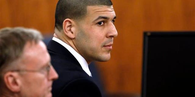 Aaron Hernandez with defense attorney Charles Rankin before the jury began deliberations on April 9, 2015.