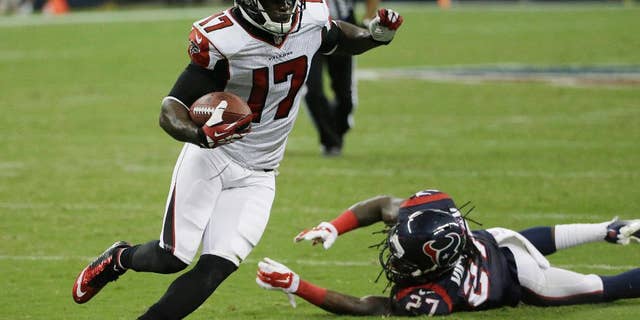 Atlanta Falcons' Devin Hester (17) evades Houston Texans' Josh Victorian (27) as he runs for a touchdown during the second quarter of an NFL preseason football game Saturday, Aug. 16, 2014, in Houston. (AP Photo/David J. Phillip)