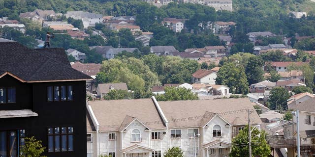 FILE - In this July 1, 2014, file photo, a new housing unit, left, is under construction in Kiryas Joel, N.Y. Agents with the FBI and other law enforcement agencies have seized documents from the Hasidic village on May 12, 2016, as part of an ongoing investigation. (AP Photo/Mike Groll, File)