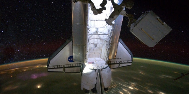 The $2 billion AMS experiment being removed from space shuttle Endeavour's cargo bay at the International Space Station.