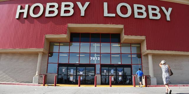Customers walk to a Hobby Lobby store in Oklahoma City, Monday, June 30, 2014. The Supreme Court ruled Monday that employers can hold religious objections that allow them to opt out of the new health law requirement that they cover contraceptives for women. The Hobby Lobby chain of arts-and-crafts stores is by far the largest employer of any company that has gone to court to fight the birth control provision. (AP Photo/Sue Ogrocki)