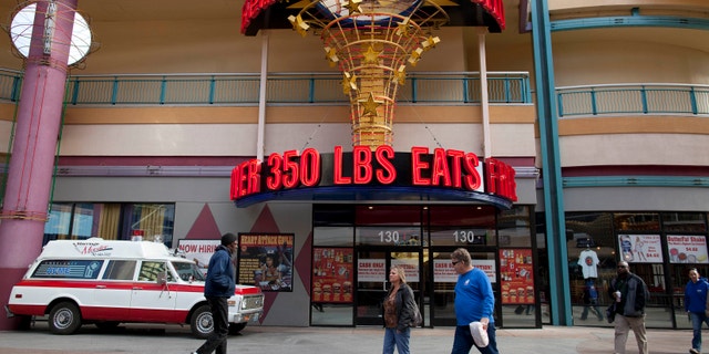 Feb. 15, 2012: Pedestrians pass by the Heart Attack Grill on Fremont Street in Las Vegas.