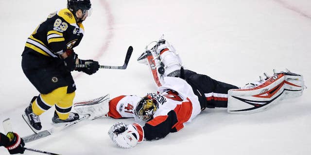 Ottawa Senators goalie Craig Anderson (41) makes a diving save on a shot by Boston Bruins left wing Brad Marchand (63) during the first period of Game 4 of a first-round NHL hockey playoff series in Boston, Wednesday, April 19, 2017. (AP Photo/Charles Krupa)