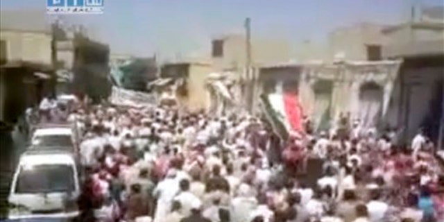In this image posted on the Internet by Shaam News Network, showing what they purport to be a demonstration in the streets of the city of Homs, Syria, on Friday Aug. 5, 2011.