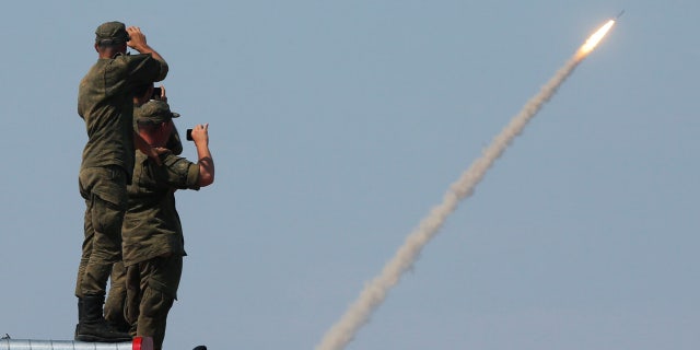 Russian servicemen watch the launch of the S-300 air defence system missile during the International Army Games 2016 at the Ashuluk military polygon outside Astrakhan, Russia, August 7, 2016.