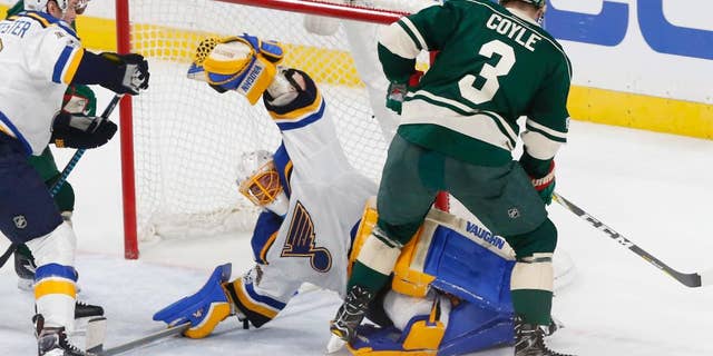 St. Louis Blues goalie Jake Allen stops a shot by Minnesota Wild's Charlie Coyle, right, during the second period of Game 1 of an NHL hockey first-round playoff series Wednesday, April 12, 2017, in St. Paul, Minn. (AP Photo/Jim Mone)