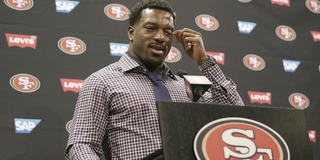 San Francisco 49ers linebacker Patrick Willis wipes his eye as he speaks at a news conference at the team's NFL football facility in Santa Clara, Tuesday, March 10, 2015. Willis, a seven-time Pro Bowler, will retire after his 2014 season was cut short by a toe injury that required surgery. (AP Photo/Jeff Chiu)