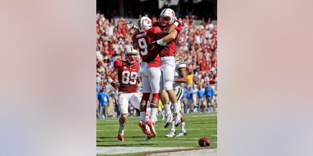 Stanford wide receiver Kodi Whitfield (9) celebrates his touchdown catch with teammate Davis Dudchock, right, during the second half of an NCAA college football game against UCLA on Saturday, Oct. 19, 2013, in Stanford, Calif. Stanford won 24-10. (AP Photo/Marcio Jose Sanchez)