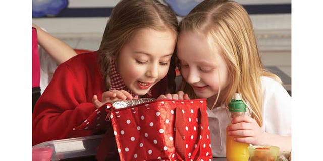FILE -- Primary school pupils enjoying packed lunch in a classroom