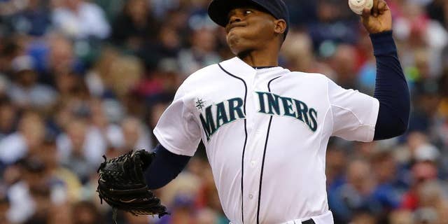 Seattle Mariners starting pitcher Roenis Elias kicks throws against the Washington Nationals during the fourth inning of a baseball game, Saturday, Aug. 30, 2014, in Seattle. (AP Photo/Ted S. Warren)