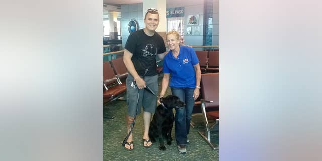 This June 30, 2016, photo provided by Molli Oliver, shows Oliver, a flight attendant with United Airlines, posing with Army Staff Sgt. Derrek Green and black lab, Zeva, after reuniting the two in El Paso, Texas. Green trained with Zeva two years ago before he was assigned to a combat engineering unit and had to leave the dog behind. Zeva stayed in kennels in Fort Leonard Wood, Mo., until Green was able to adopt her. It is the fifth time Oliver has helped reunite a retired military dog with its former handler. (Molli Oliver via AP)