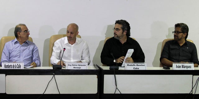 Humberto de la Calle, head of Colombia's government negotiation team, left, and Ivan Marquez, chief negotiator for the Revolutionary Armed Forces of Colombia, or FARC, right, talk during a press conference accompanied by Cuban guarantor Rodolfo Benitez, second from right, and Norwegian guarantor Dag Nylander, second from left, at the close of another round of peace talks in Havana, Cuba, Saturday, March 7, 2015. Colombiaâs government and the FARC have agreed to begin a pilot program for removing land mines as part of efforts to lower the intensity of a conflict that has lasted a half century. The announcement came Saturday at the end of the latest round of peace talks being held in Cubaâs capital since November 2012. (AP Photo/Ismael Francisco, Cubadebate)