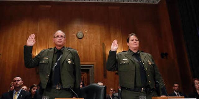 FILE - In this Nov. 30, 2016 file photo, Customs and Border Protection U.S. Border Patrol Chief Mark Morgan, left, and Deputy Chief Carla Provost, are sworn in during a hearing of the Senate Committee on Homeland Security and Governmental Affairs concerning border protection on Capitol Hill in Washington. Ronald Vitiello now acting deputy commissioner of Customs and Border Protection has named his deputy, Carla Provost, acting Border Patrol chief. She is the first woman to lead the agency. (AP Photo/Alex Brandon, File)