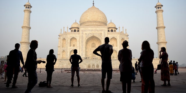 Tourists visit India's famed monument of love, the Taj Mahal, in Agra, India, Thursday, March 22, 2018. The 17th century white marble monument is India's biggest tourist draw, with about 3 million visiting every year. (AP Photo/R.S. Iyer)