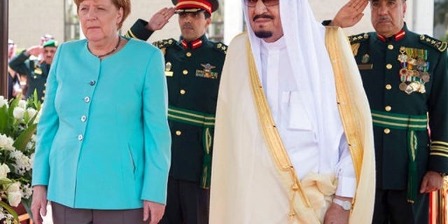 In this photo released by the Saudi Press Agency, SPA, German Chancellor Angela Merkel, left, is received by Saudi King Salman on her arrival to Jiddah, Saudi Arabia, Sunday, April 30, 2017. Merkel arrived Sunday for talks with the oil-rich kingdom's monarch, beginning a two-nation trip to the Gulf. (Saudi Press Agency via AP)