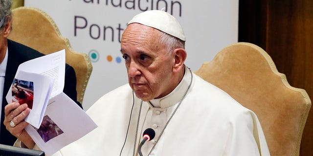Pope Francis show pictures of killed children during a meeting with the Scholas Occurrentes, an educational organization founded by the pontiff, on May 29, 2016. 