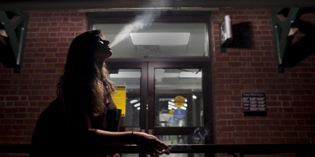 SUMMIT, NJ - JUNE 22: Matilde Hoffman smokes a cigarette with friends after getting off the train June 22, 2012 in Summit, New Jersey.Matilda graduated from University of Southern California in December of 2011 with a bachelors degree in neuroscience. Since graduating she has applied to over 30 different jobs, gone on 3 interviews, and had no luck finding a full time job. In the meantime she has been working two part time hostess jobs and volunteering with New York Cares. In June, on a whim, she applied to a one year medical science program at Drexel University at was recently accepted. ''I was tired of the job search. All this looking for a job, volunteering and shuffling around to two part time jobs was getting stressful. If that's the only opportunity I have, if nothing else comes my way, I should do it. If this is what life has brought to me at the moment I should take it.'' she said. From 2000 to 2010 the number of waiters and waitresses ages 18 to 30 with college degrees increased 81 percent according to the U.S. Census Bureau. Educated bartenders, dishwashers in that age group doubled. Recently the Associated Press reported that ''About 1.5 million, or 53.6 percent, of bachelor's degree-holders under the age of 25 last year were jobless or underemployed, the highest share in at least 11 years.'' (Photo by Allison Joyce/Getty Images)