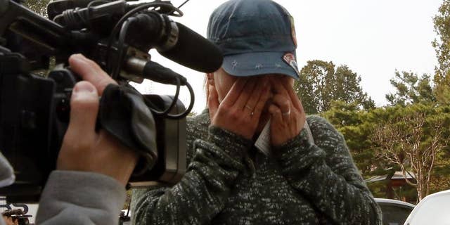 A representative of sex workers wipes her tears after listening to a judgment at the Constitutional Court in Seoul, South Korea, Thursday, March 31, 2016. South Korea's constitutional court on Thursday upheld laws that toughened punishment on prostitutes, pimps and their clients. he 2004 legislation drove thousands of sex workers in traditional red-light zones out of business in South Korea, but prostitution has still thrived in the shadows. (AP Photo/Lee Jin-man)