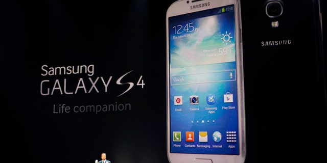 JK Shin, President and Head of IT and Mobile Communications for Samsung Electronics, presents the new Samsung Galaxy S 4 during the Samsung Unpacked event at Radio City Music Hall, Thursday, March 14, 2013 in New York. (AP Photo/Jason DeCrow)