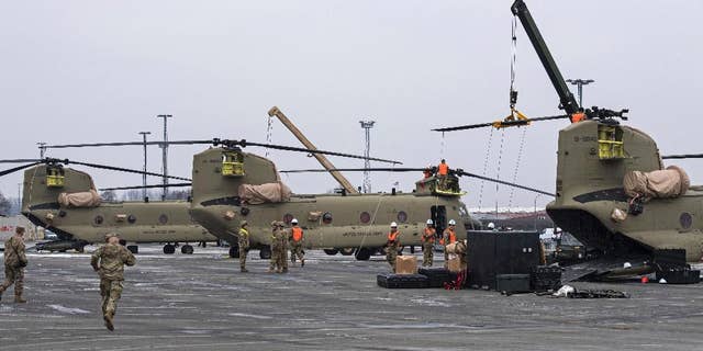 U.S. Technicians prepare helicopters for the transport in Bremerhaven, northern Germany, Sunday Feb. 12, 2017. (Ingo Wagner/dpa via AP)