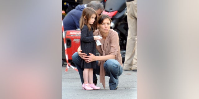 Katie Holmes and Suri Cruise watching Tom Cruise and Cameron Diaz on the set of "Knight and Day" in December 2009.