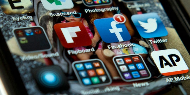 A view of an iPhone in Washington May 21, 2013, showing the Twitter and Facebook apps among others.