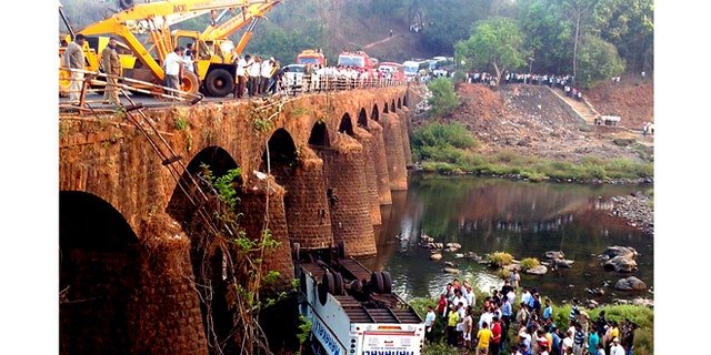 March 19, 2013: Rescuers and others gather at the site of a bus accident in Ratnagiri district, in the western Indian state of Maharashtra.