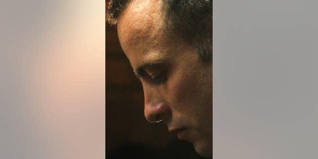 FILE - in this Friday, Feb. 22, 2013 file photo, Olympic athlete Oscar Pistorius stands in the dock during his bail hearing at the magistrate court in Pretoria, South Africa. With his athletic triumphs tarnished by the killing of his girlfriend, Reeva Steenkamp. Pistorius, now 27, faces possibly being sent to prison until he is older than 50. Pistorius goes on trial Monday March 3, 2014. (AP Photo/Themba Hadebe, File)