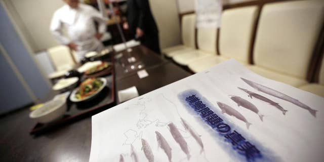FILE - In this Nov. 19, 2014 file photo, booklets titled "The Truth of Whaling Problem" are placed next to whale meat dishes on display at a cafeteria of Ministry of International Trade and Industry in Tokyo as it started to serve whale meat. Japan aims to resume whale hunts in the Antarctic later this year, even though the International Whaling Commission says Tokyo hasn't proven that the mammals need to be killed for research. The IWC's Scientific Committee said in a report Friday, June 19, 2015 that it wasn't able to determine whether lethal sampling is necessary for whale stock management and conservation. (AP Photo/Eugene Hoshiko, File)