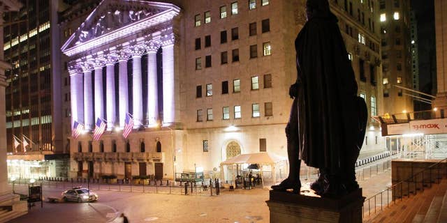 A statue of George Washington stands near The New York Stock Exchange, background, Wednesday, Oct. 8, 2014 in New York. World stock markets mostly retreated Thursday Nov. 6, 2014 as investors awaited a European Central Bank policy meeting and a U.S. jobs report that might deliver a verdict on whether the Federal Reserve's withdrawal of stimulus was warranted. (AP Photo/Mark Lennihan)