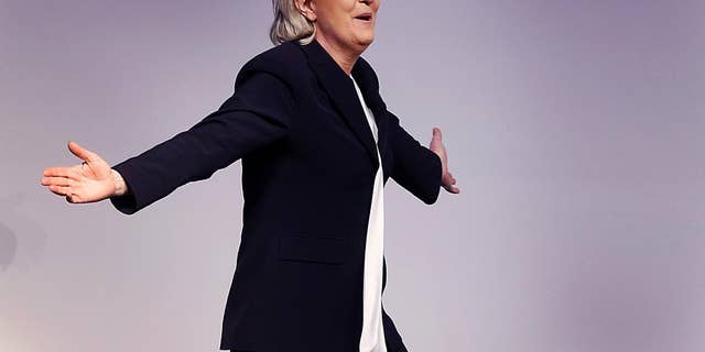FILE - In this Saturday, Jan. 21, 2017 file photo, far-right leader and candidate for next spring presidential elections Marine le Pen from France celebrates after her speech at a meeting of European Nationalists in Koblenz, Germany. The European parliament is asking France's far-right leader Marine Le Pen to start repaying hundreds of thousands euros it says were wrongly paid to legislative aides. An EU parliament letter to le Pen published by Challenges magazine gives Tuesday as the deadline to begin repayment of about 300,000 euros ($322,000). (AP Photo/Michael Probst, File)