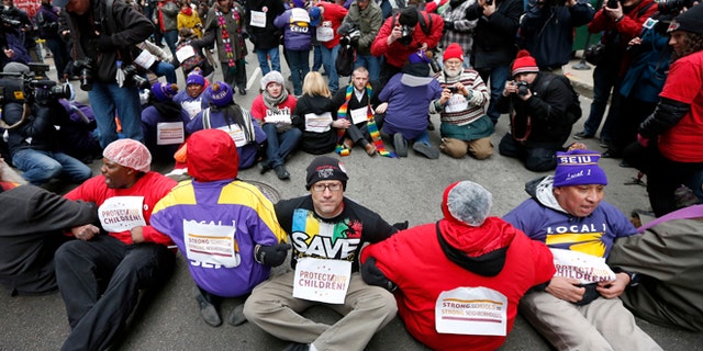 March 27, 2013: Protesters sit on LaSalle Street during an act of civil disobedience over a plan to close 54 Chicago Public Schools in Chicago's downtown.