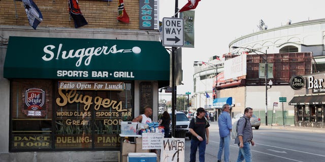 FILE - This Sept. 21, 2010 file photo shows Sluggers Sports Bar and Grill near Wrigley Field, background, before a Chicago Cubs baseball game in Chicago. On Thursday, May 30, 2013, Sami Samir Hassoun, a Lebanese immigrant, is scheduled to be sentenced at federal court in Chicago for placing a backpack he thought held a bomb outside the bar in September 2010. Prosecutors want a 30-year prison sentence for the 25-year-old, who pleaded guilty to weapons charges last year. The defense filing argues Hassoun deserves no more than 20 years, in part because they contend he was egged on by an FBI informant to concoct the bombing scheme. (AP Photo/Charles Rex Arbogast, File)