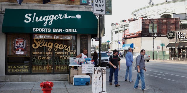 FILE - This Sept. 21, 2010 file photo shows Sluggers Sports Bar and Grill near Wrigley Field, background, before a Chicago Cubs baseball game in Chicago. On Thursday, May 30, 2013, Sami Samir Hassoun, a Lebanese immigrant, is scheduled to be sentenced at federal court in Chicago for placing a backpack he thought held a bomb outside the bar in September 2010. Prosecutors want a 30-year prison sentence for the 25-year-old, who pleaded guilty to weapons charges last year. The defense filing argues Hassoun deserves no more than 20 years, in part because they contend he was egged on by an FBI informant to concoct the bombing scheme. (AP Photo/Charles Rex Arbogast, File)