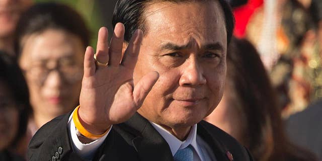 FILE - In this Saturday, July 16, 2016, file photo, Thailand's Prime Minister Prayuth Chan-ocha waves as he arrives for a group photo of leaders at the 11th Asia-Europe Meeting (ASEM) in Ulaanbaatar, Mongolia. On Wednesday, Prime Minister Prayuth defended the military detention of "so-called political prisoners," saying they are given good housing and food, but that they sometimes complain about things like the quality of air conditioning. (AP Photo/Mark Schiefelbein, File)