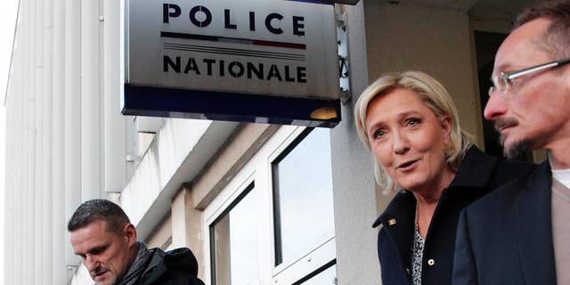 French far-right presidential candidate Marine Le Pen leaves after a meeting at the Juvisy-sur-Orge police station, south of Paris, France, as she campaigns for the upcoming presidential election, Tuesday, Feb. 7, 2017. (AP Photo/Christophe Ena)