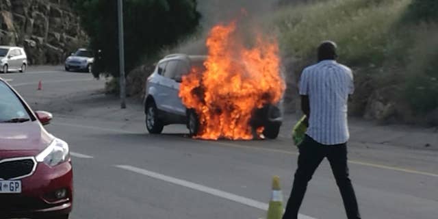 In this photo taken Thursday, Jan. 12, 2017 the 2013 Ford Kuga owned by Warren Krog burns out in Alberton JohannesburgThe South African unit of the Ford Motor Company says it is recalling 4,556 Kuga vehicles following several dozen reports of the car catching fire. Jeff Nemeth, Ford's regional chief executive, said Monday Jan. 16 2017, that 1.6-liter Kugas made between December 2012 and February 2014 must be taken to a Ford dealer as soon as possible. (AP Photo/Warren Krog)
